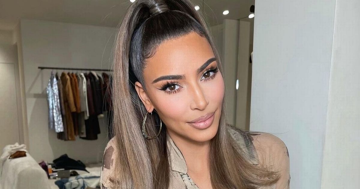 Kim Kardashian smiles for the camera after posing without her wedding ring